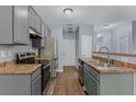 Modern kitchen with stainless steel appliances, grey cabinets, and durable countertops at 2825 Windsor Forrest Ct, Atlanta, GA 30349