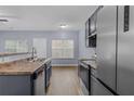 Bright kitchen featuring stainless steel appliances, durable countertops, and a window view at 2825 Windsor Forrest Ct, Atlanta, GA 30349