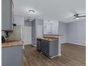 Open kitchen concept flowing to the living room with modern fixtures and luxury vinyl plank flooring at 2825 Windsor Forrest Ct, Atlanta, GA 30349