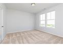 Spacious bedroom with plush carpet and lots of natural light from two large windows at 616 Devon Aly, Acworth, GA 30102