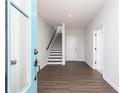 Bright entryway features beautiful dark wood-look floors and a staircase leading to the upper level at 616 Devon Aly, Acworth, GA 30102