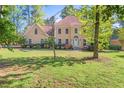Stately two-story home with a lush front yard and mature landscaping at 7389 Tidewater Trce, Stone Mountain, GA 30087