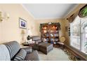 Cozy living room with comfortable seating, built-in bookcase, and ample natural light at 1810 Valley Brook Dr, Alpharetta, GA 30005