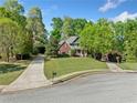 Beautiful two-story brick home with lush landscaping and a long driveway at 204 Overland Trl, Mcdonough, GA 30252