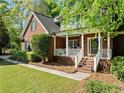 Inviting brick home with a cozy front porch and well-maintained landscaping at 204 Overland Trl, Mcdonough, GA 30252