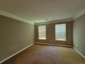 Spacious living room featuring two windows, neutral-toned walls and plush carpeting at 2752 Live Oak Trl, Atlanta, GA 30349