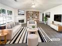 Bright living room featuring a fireplace, modern furniture, and ample natural light at 6028 Arbor Links Rd, Lithonia, GA 30058