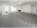 Large living room with neutral carpet, fireplace, bright windows and a glass door at 6028 Arbor Links Rd, Lithonia, GA 30058
