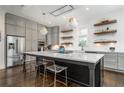 Modern kitchen with stainless steel appliances, large center island, and stylish pendant lighting at 216 Haralson Ne Ln, Atlanta, GA 30307