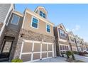 A series of attractive townhomes with brick and siding exteriors, each featuring a two-car garage at 38 Trailview Ln, Hiram, GA 30141