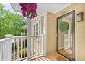 Inviting front porch with hanging flower basket and wreath on the front door of this charming home at 5566 River Heights Se Xing, Marietta, GA 30067