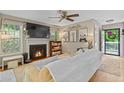 Cozy living room with a fireplace, large TV, neutral colors, and natural light at 5566 River Heights Se Xing, Marietta, GA 30067