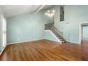 Bright living room with hardwood floors, vaulted ceilings, and staircase with iron railing at 1214 Defoors Nw Ct # 1A, Atlanta, GA 30318
