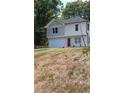 Well-manicured two-story home featuring an attached garage and neatly kept front lawn at 1331 E Atlanta E Rd, Stockbridge, GA 30281