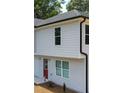 Well-designed two-story home featuring a red door and a freshly mulched front yard at 1331 E Atlanta E Rd, Stockbridge, GA 30281