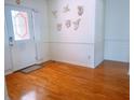 Entryway with hardwood floors, decorative wall art, and white door with stained glass at 385 Bethesda Park Trl, Lawrenceville, GA 30044