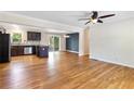 Open-concept living space featuring hardwood floors, recessed lighting, and seamless flow to dining and kitchen at 4462 Cain Cir, Tucker, GA 30084