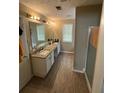 Bright bathroom featuring double vanity with granite countertop and modern fixtures at 1086 Deshon Trl, Lithonia, GA 30058