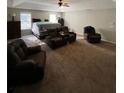 Spacious main bedroom featuring neutral walls, fan, sitting area, and a plush carpet at 1086 Deshon Trl, Lithonia, GA 30058