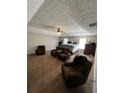 Spacious main bedroom featuring neutral walls, fan, sitting area, and a plush carpet at 1086 Deshon Trl, Lithonia, GA 30058