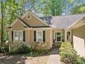Close up of a charming one-story home with a well-manicured front yard and inviting entrance at 614 Springharbor Dr, Woodstock, GA 30188