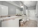 Bathroom featuring double sinks, tile floors, and a shower/tub combo at 10 Perimeter Summit Ne Blvd # 2207, Brookhaven, GA 30319