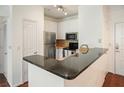 Modern kitchen features stainless steel appliances, granite countertops, and white cabinetry at 10 Perimeter Summit Ne Blvd # 2207, Brookhaven, GA 30319