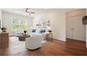 Bright living room with hardwood floors, stylish furniture, and natural light from a large window at 10 Perimeter Summit Ne Blvd # 2207, Brookhaven, GA 30319