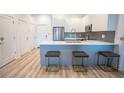 Stylish kitchen island with seating, complemented by modern appliances and sleek cabinetry at 1155 Custer Se Ave # 201, Atlanta, GA 30316