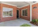 Brick home porch with house number, black front door, and well-maintained landscaping at 1304 Brookhavenrun Cir, Duluth, GA 30097
