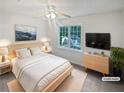 Well-lit bedroom with a large window, ceiling fan, and modern furnishings at 1307 Chandler Nw Ct, Acworth, GA 30102