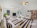 Bright living room featuring fireplace, ceiling fan, and large windows at 1307 Chandler Nw Ct, Acworth, GA 30102