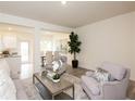 Open-concept living area features a comfortable seating arrangement, seamlessly connected to the kitchen and dining space at 2688 Ne Almand Ln, Conyers, GA 30013