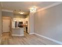Open floor plan showcasing kitchen with modern lighting, stainless appliances, and breakfast bar at 400 17Th St # 1114, Atlanta, GA 30318