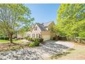 Featuring an attached garage, long driveway and basketball hoop, this home offers curb appeal and outdoor enjoyment at 1010 Forest Creek Dr, Canton, GA 30115