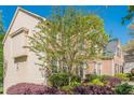 Brick and siding home featuring mature trees and landscaping on a sunny day at 1010 Forest Creek Dr, Canton, GA 30115