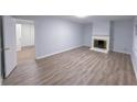 Spacious living room featuring hardwood floors, a fireplace, and neutral paint for versatile decor at 2637 Sol Ct, Ellenwood, GA 30294
