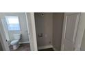 Bathroom featuring a toilet next to a laundry area at 2917 Joe Jerkins Blvd, Austell, GA 30106