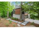 Contemporary home showcasing a stylish facade with clean lines, landscaped front yard, and a driveway at 5276 Weatherwood Trce, Marietta, GA 30068