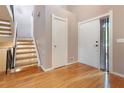 Bright foyer with hardwood floors, staircase, and white doors providing access to rooms at 5276 Weatherwood Trce, Marietta, GA 30068