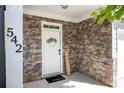 Inviting entrance with stone facade, 'Welcome' sign, and well-decorated door with a black 'hello' door mat at 542 Broughton Dr, Canton, GA 30114