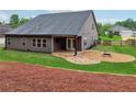 Spacious backyard with a covered patio, gravel fire pit, perfect for outdoor entertaining at 6340 Arlington Cir, Cumming, GA 30041