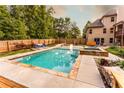 Inviting pool area with stone accents, manicured landscaping and lounge seating near spa at 632 Creekside Trce, Covington, GA 30014
