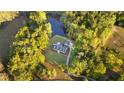 Aerial view of estate featuring a beautiful home and a private lake, all surrounded by lush greenery at 576 Tope Rd, Sharpsburg, GA 30277
