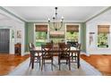 Traditional dining room with wood floors, green walls, and windows with natural light at 576 Tope Rd, Sharpsburg, GA 30277