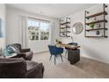 Comfortable home office with built-in shelving, a desk, and cozy seating area at 90 Hampton Ter, Dallas, GA 30157