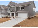 Beautiful two-story gray house with white trim, a large driveway, and a well-maintained lawn at 131 Hampton Ter, Dallas, GA 30157