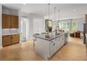 Open kitchen with a center island, pendant lighting, stainless appliances, and hardwood flooring at 1428 Wicker Wood Se Pl # 8, Smyrna, GA 30080