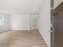 Bright, open living room featuring durable, light wood-look flooring, recessed lighting, and an arched doorway at 171 Hampton Ter, Dallas, GA 30157