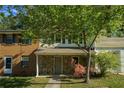 Attractive townhome showcasing a stone facade, covered porch, and landscaped front yard at 2294 Salt Springs Pl, Austell, GA 30168